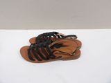 black leather sandals with black laces on them on a white surface