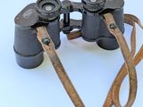 a pair of binoculars that are sitting on a white surface