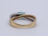 an image of a gold ring with a green stone on top of it
