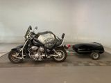 a motorcycle parked next to a car on a checkered floor