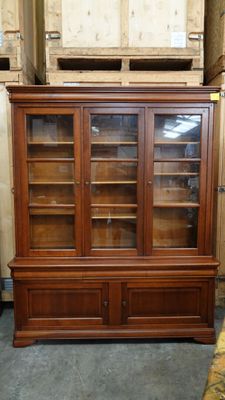 Bibliothèque en merisier vitrée en partie haute.