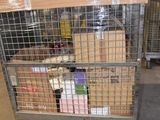 a large metal cage with boxes on it in a warehouse