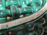 a close up of a green vase with a name on it