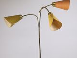 three lamps on a metal stand with a wooden base