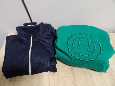 two shirts that are sitting on a wooden table