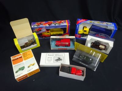 many different types of toy trains in boxes on a table