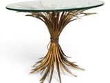 a round glass table with gold metal and glass top