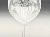 a wine glass that has a red label on it
