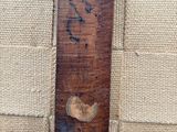 a close up of a piece of wood with a bird on it