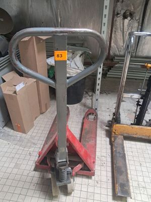a fork lift in the middle of the floor in a garage