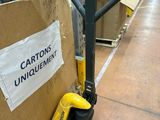a carton with a sign on it in a warehouse