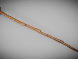 an old wooden stick with a long handle sitting on a table