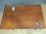 a small wooden table with flowers on top of it