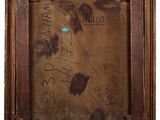 an old picture of a painting with writing on it in a wooden frame
