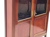 a wooden cabinet with two glass doors on it