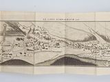 an old map of a town on a piece of paper on a table