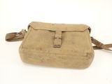 an old tan canvas bag with a brown leather handle on a white background