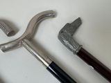 two different types of walking canes on a white surface