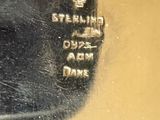 a close up of a silver plate with a name on it
