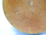 a brown vase with writing on it sitting on a table