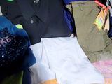 a pile of clothes sitting on a table in a room