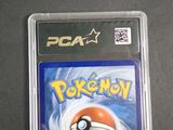 the pokemon card is in the plastic case on the table