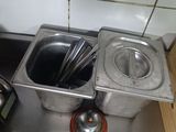 a metal sink with a metal container and a metal spoon