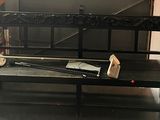a black bench with a baseball bat on it in a room