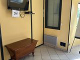 a television in the corner of a room with tile flooring