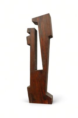 a wooden sculpture of a man and a woman on a white background