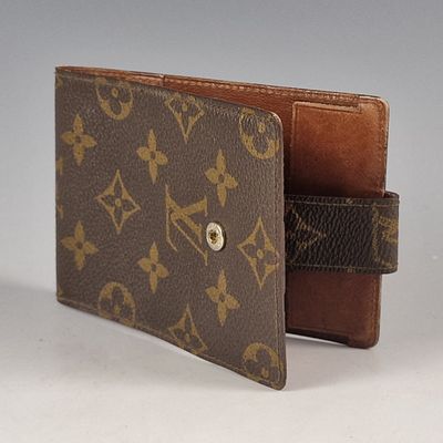 louis vuittou wallet with a brown leather case and a brown leather strap