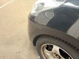 a close up of a car ' s tire on a parking lot