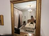 a mirror in the corner of a room with a bed in it