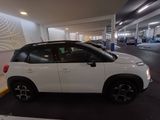 a picture of a white car parked in a parking garage