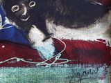 a painting of a black and white dog on a red and blue blanket