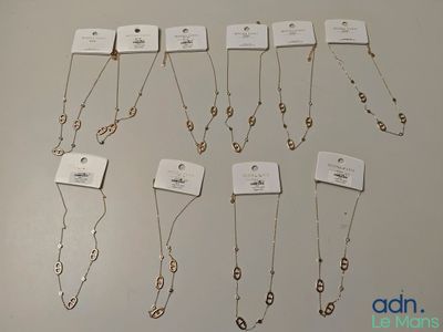 a lot of necklaces that are on display on the table