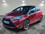 a red toyota yaris parked on a checkered floor