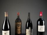 three bottles of wine are lined up on a table