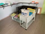 a desk with a file cabinet in the corner of the room