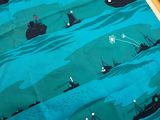 a picture of a table cloth with a picture of ships on it