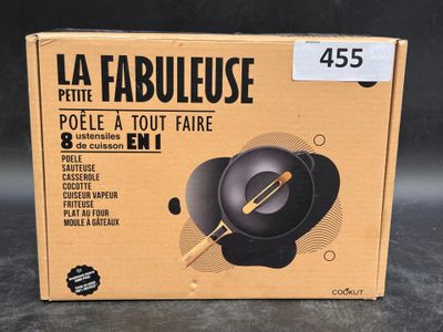 the box of a black frying pan is on the table