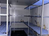 a room with bunk beds in it and boxes on the floor