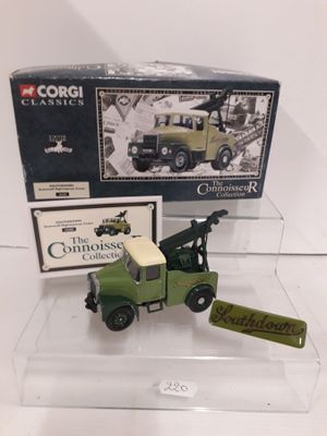 a green toy truck with a crane on top of it
