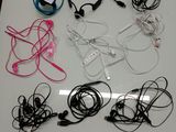 a white table topped with headphones and cords