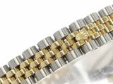an image of a close up of a gold and silver bracelet