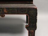 an image of a small table with a black and red design on it