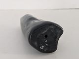 a close up of a small black object on a white surface