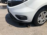 a white car parked in a parking lot with other cars in the background