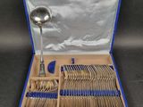 silverware in a blue case with a spoon, spoon and spoon rest