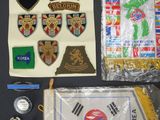 a lot of patches and badges on the table